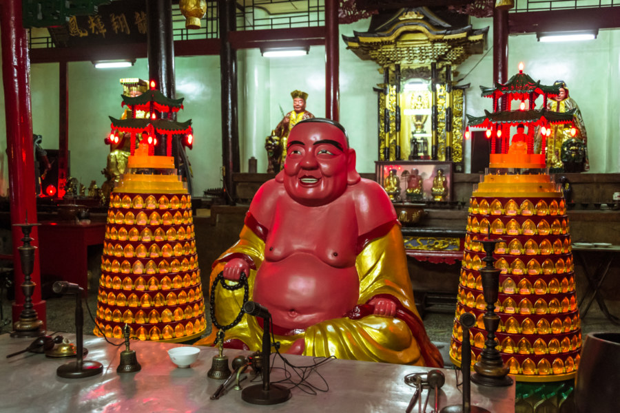 A chubby red Buddha in a temple in Changhua City
