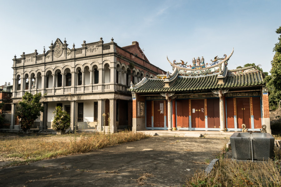 A western-style mansion next to a Chinese-style shrine