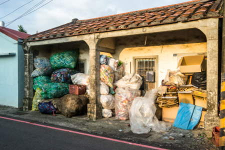 Storing trash next to an old building in Xinpi Township